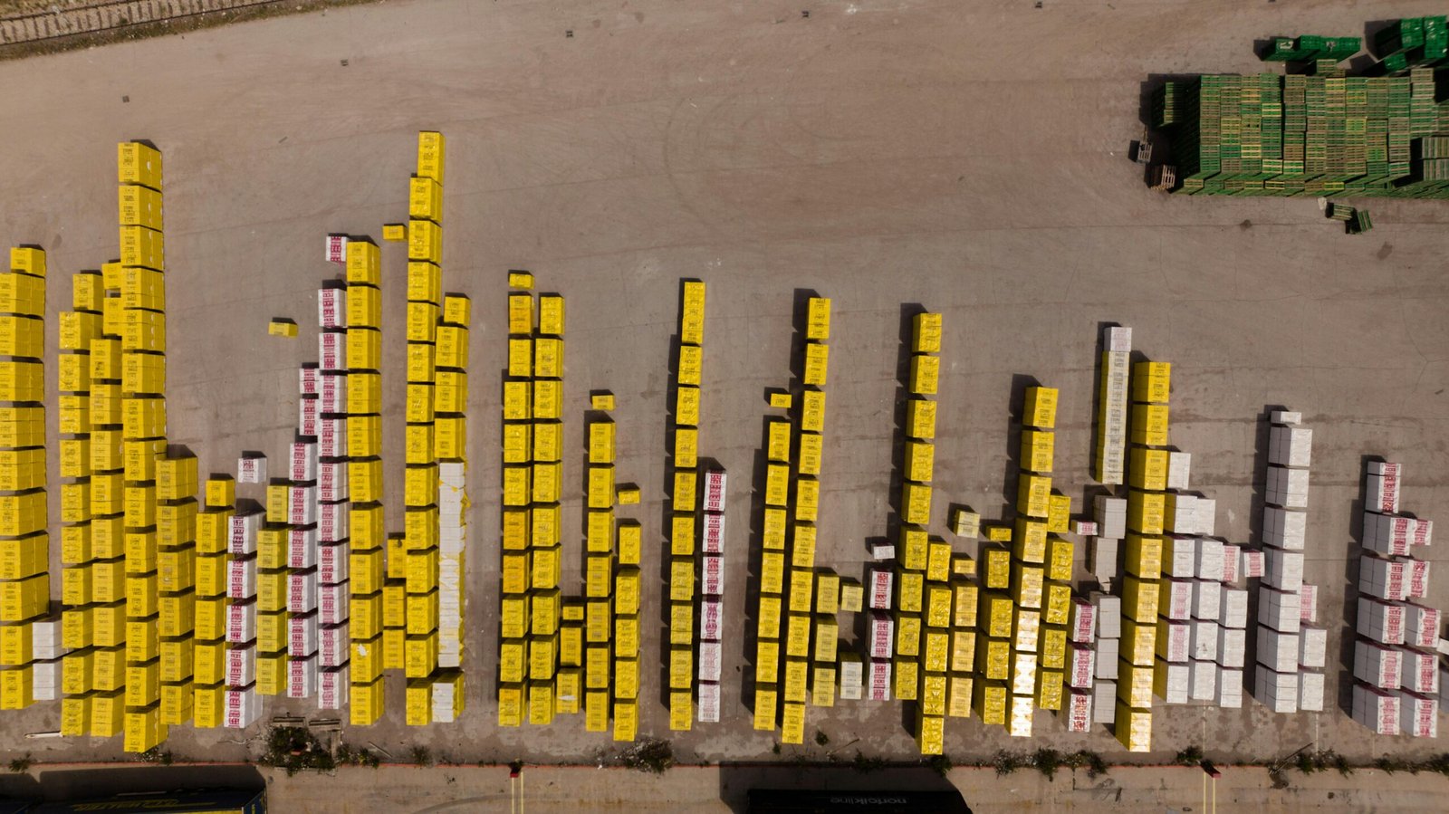 Close-up shot of a frozen bubble with warm reflections resting on a snowy surface at twilight.